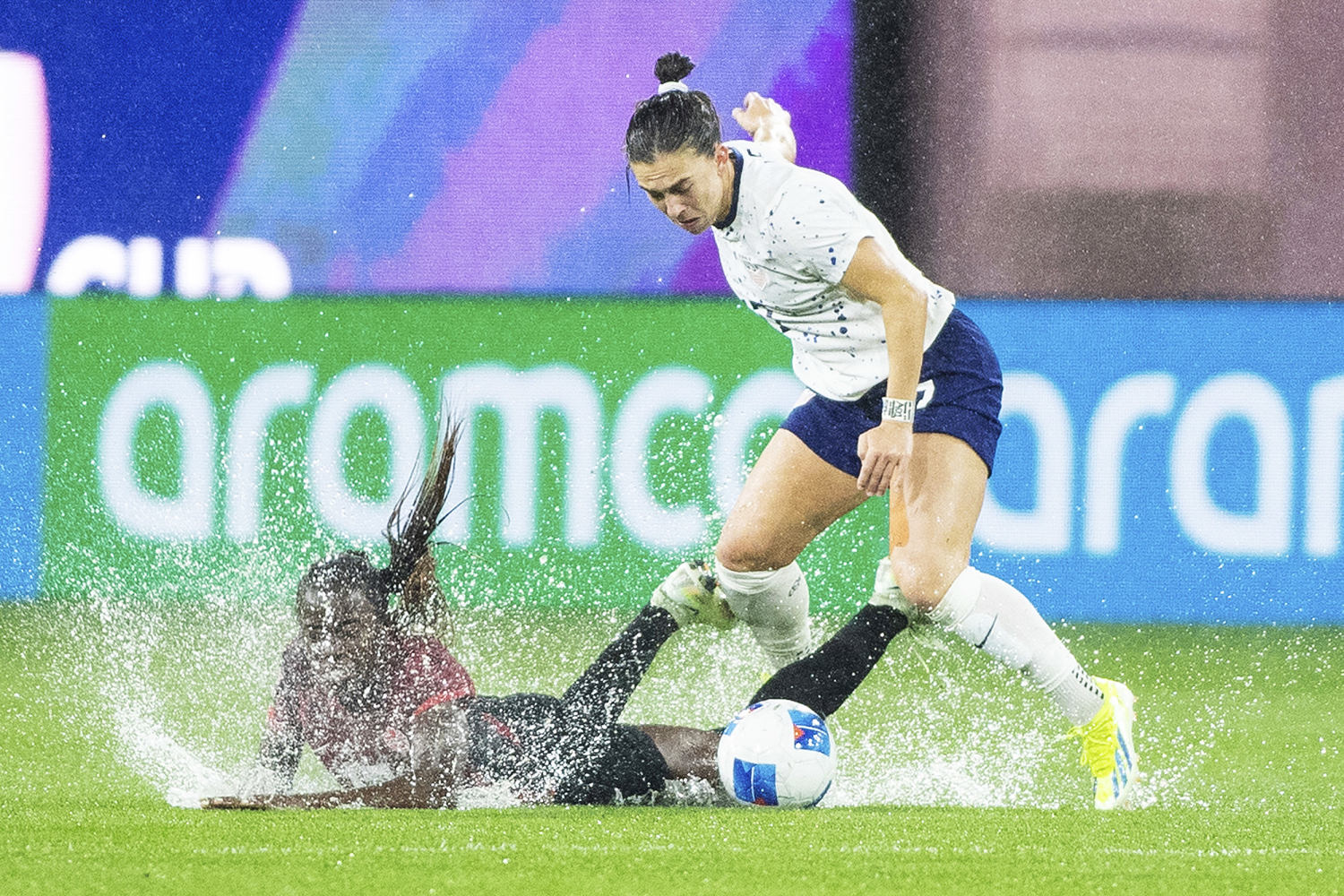 U.S. women beat Canada in dramatic game of puddles and penalty kicks