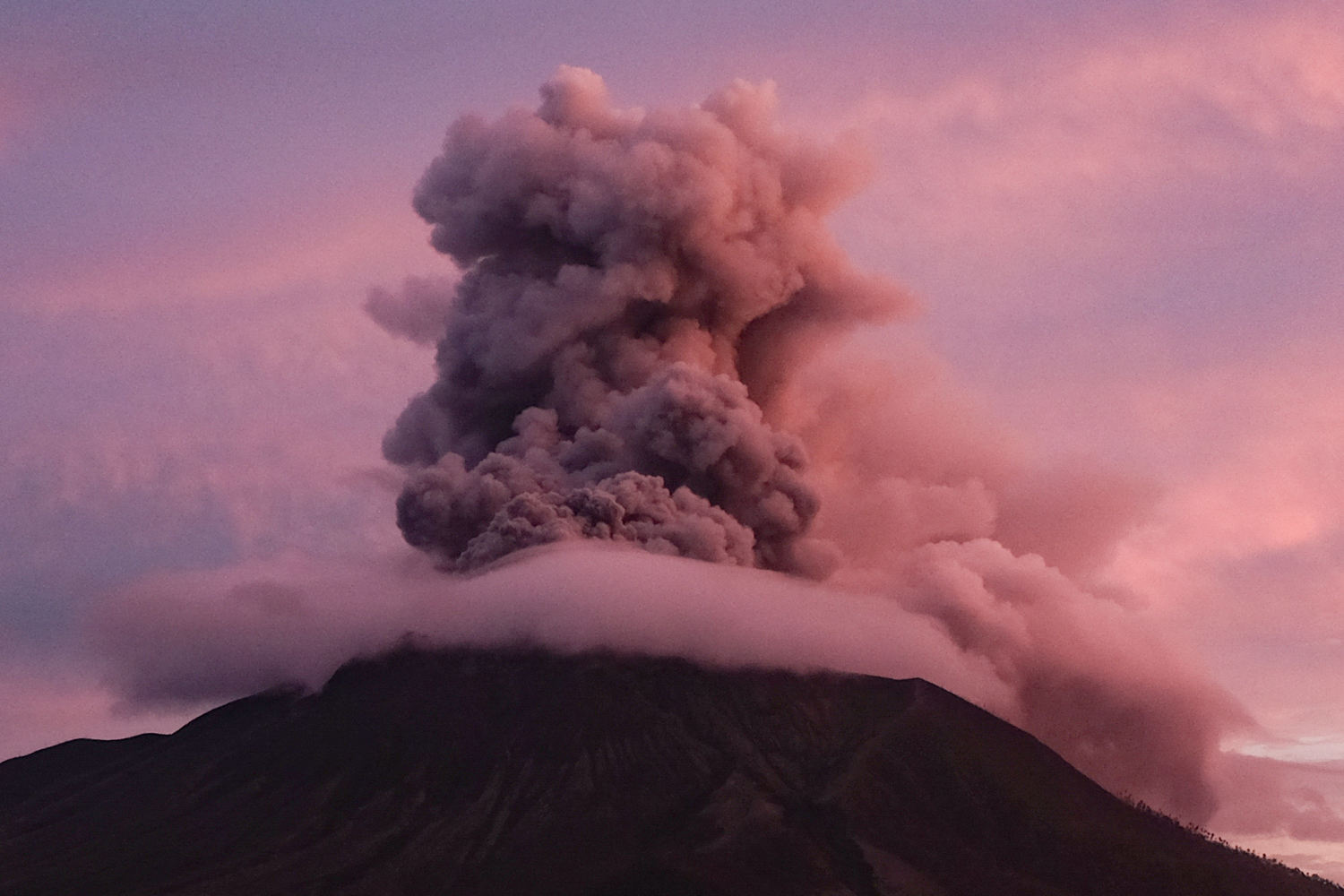 More than 2,100 people are evacuated as an Indonesian volcano spews clouds of ash