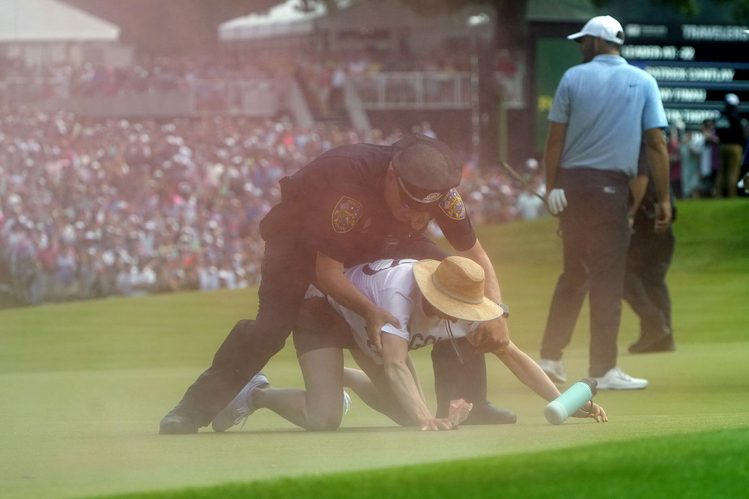 Protesters storm the 18th green at Travelers Championship