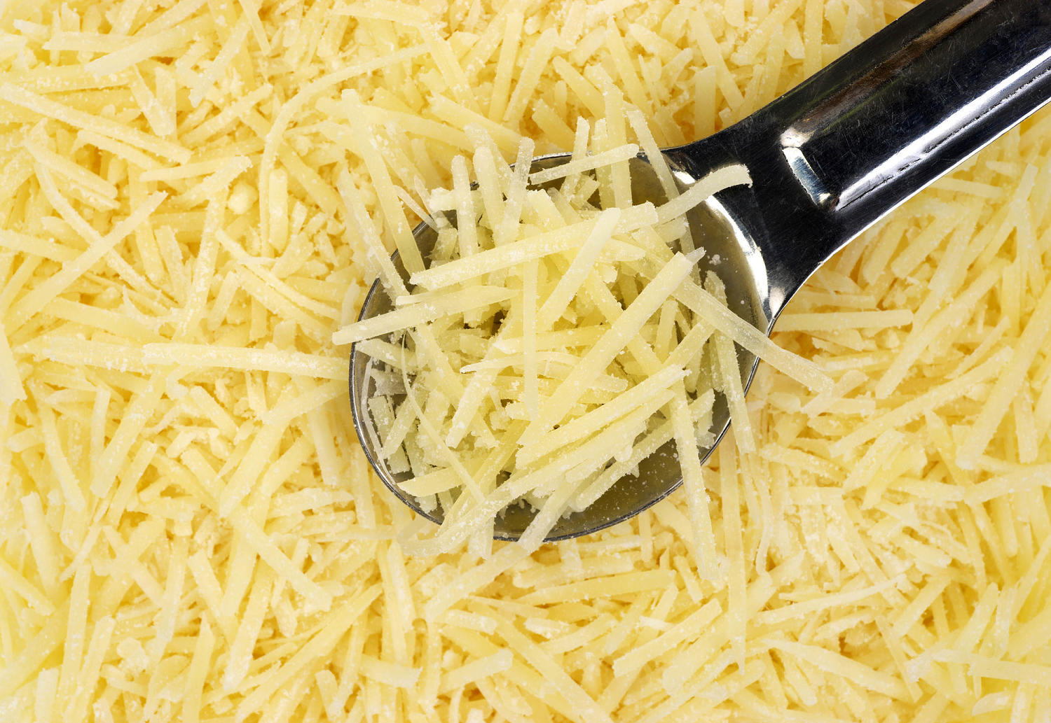 What is that powder on shredded cheese, and is it bad for you? A dietitian explains