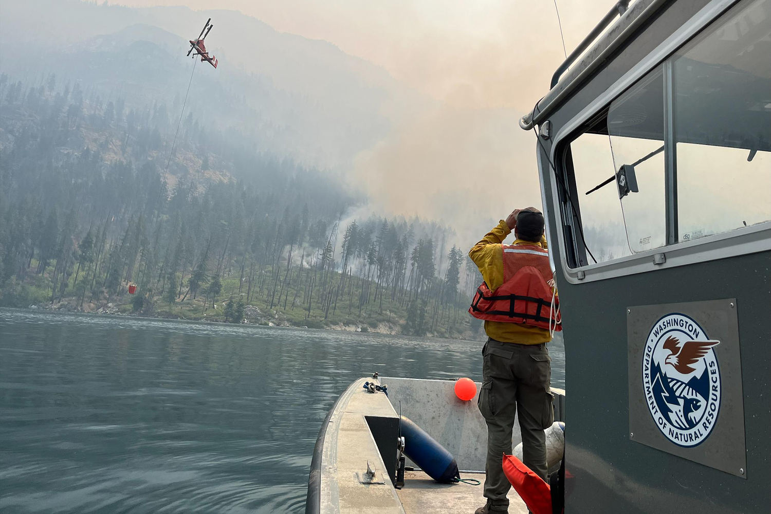 With a fire burning just miles away, residents of a Washington town dig in