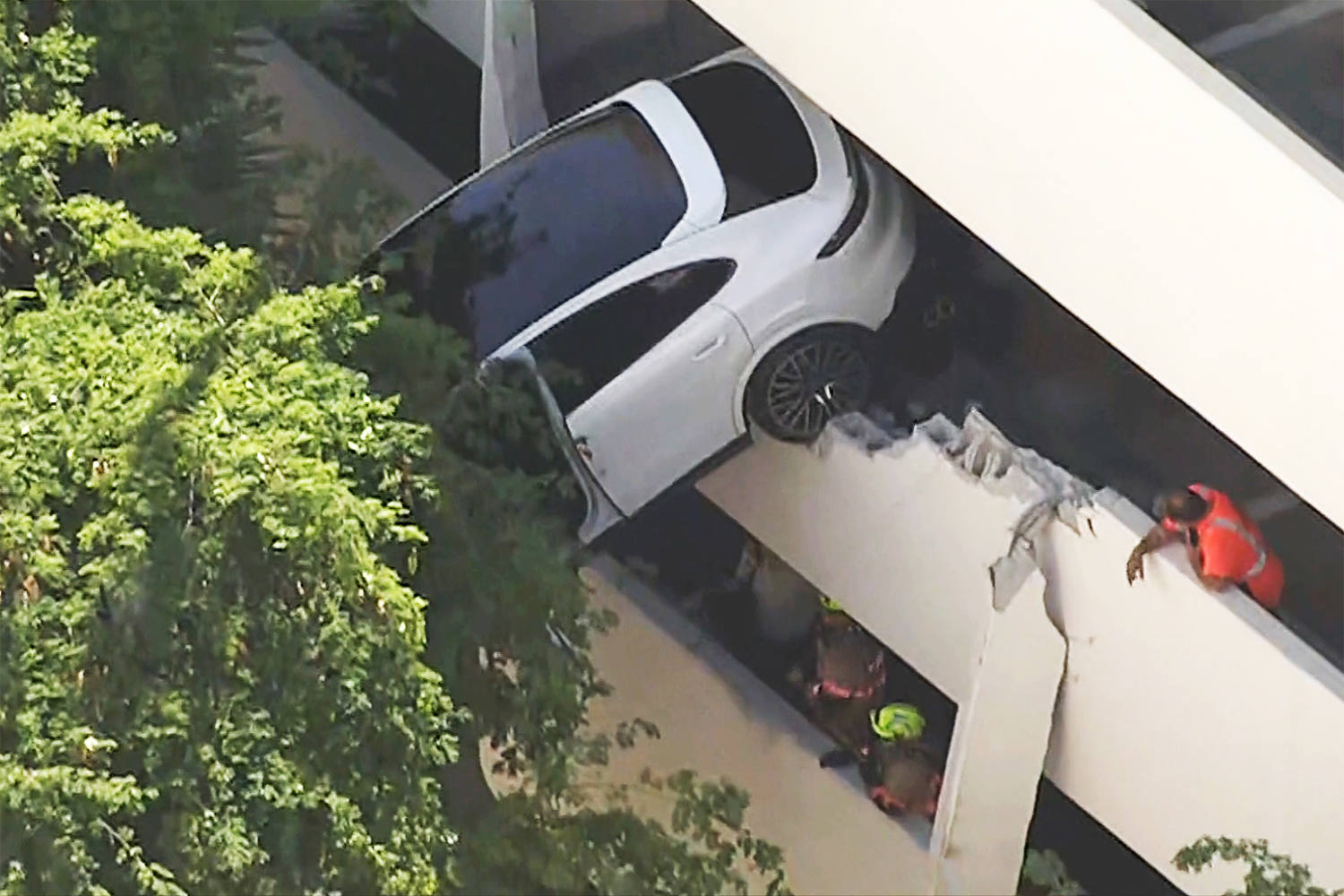 Woman rescued after crash leaves Porsche dangling from Florida parking garage