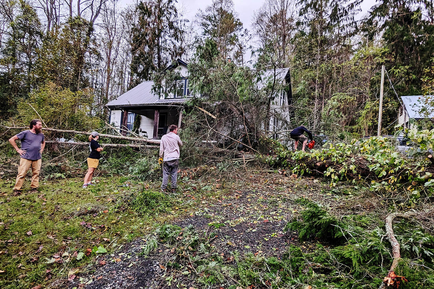 Raft guides turned rescuers shovel Appalachian river mud and clear trees in Florida