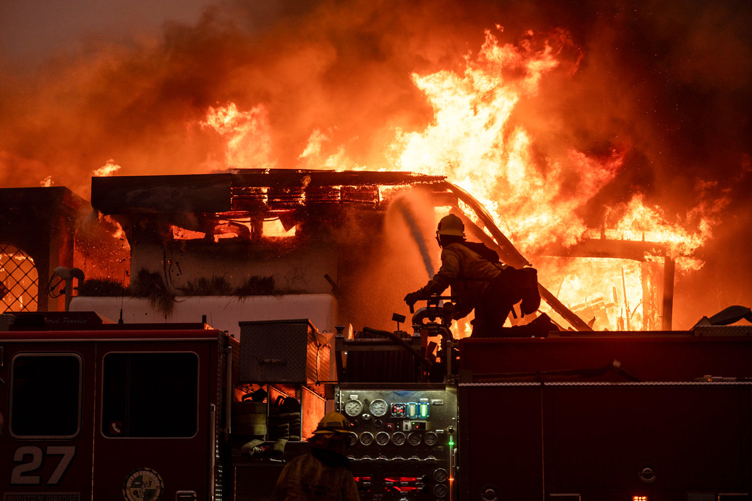 Los Angeles wildfires kill two and trigger exodus as firefighters battle blazes