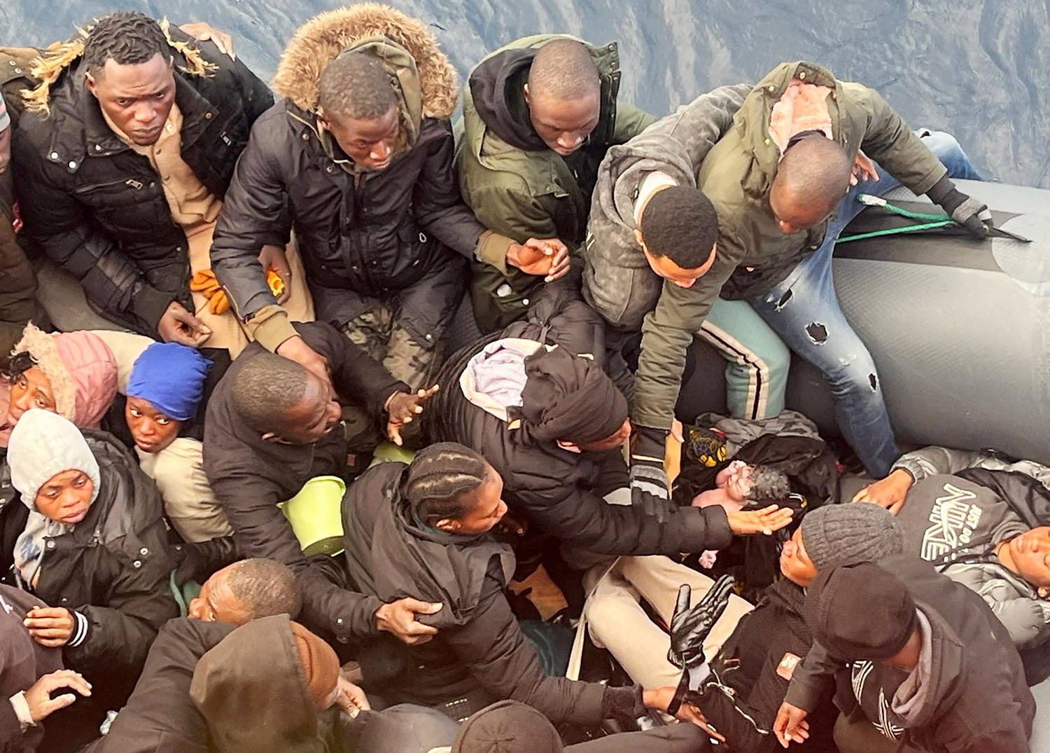 Photo shows the rescue of a baby born at sea on a crowded migrant boat