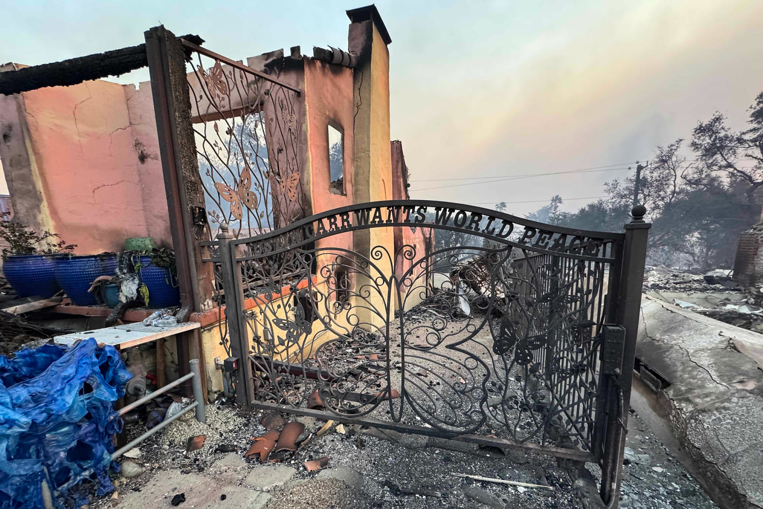 The family home is gone. The gate in their son's honor still stands.