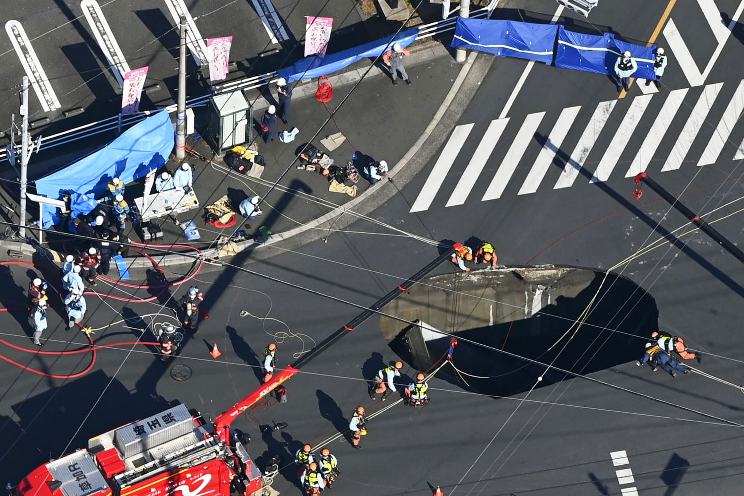 Swimming pool-sized sinkhole swallows truck in Japan, trapping driver inside