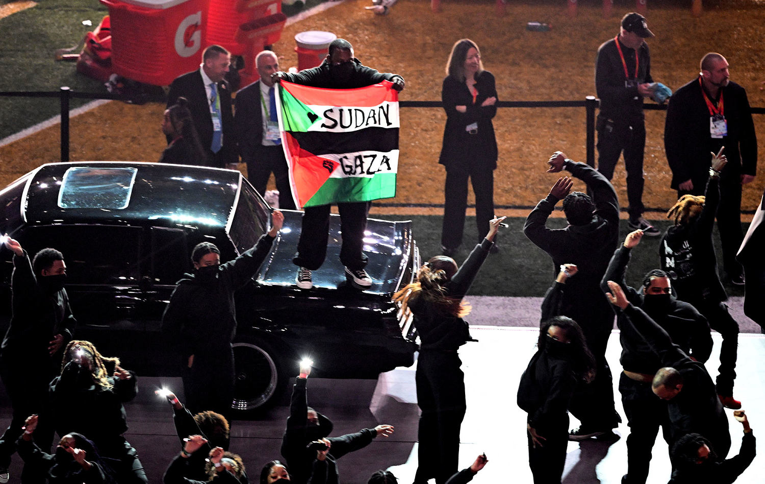 Super Bowl halftime show dancer displays Palestinian, Sudanese flags during Kendrick Lamar performance