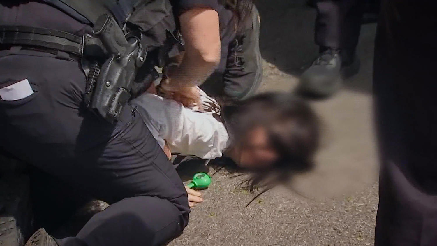 Massachusetts police hold girl's face to the ground as ICE arrests her mother, video shows
