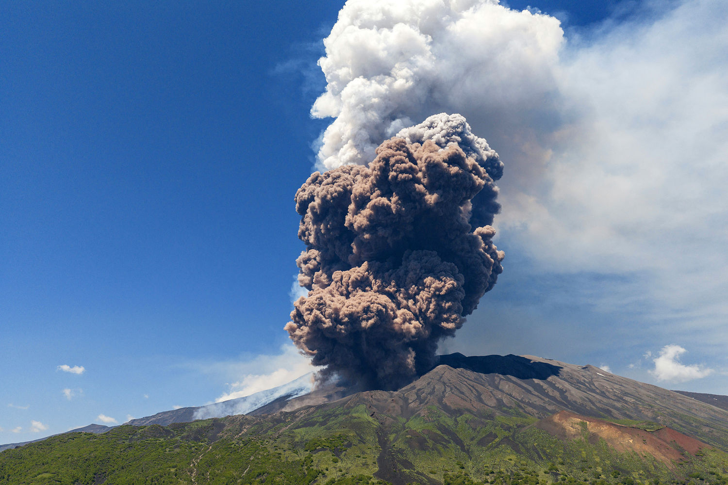 Sicily's Mount Etna erupts in a fiery show of miles-high smoke and ash