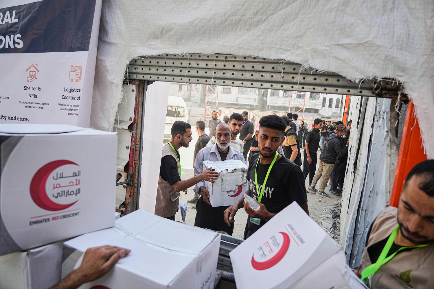 Israel halts aid, official says, as Palestinian clans in Gaza deny Hamas is stealing it