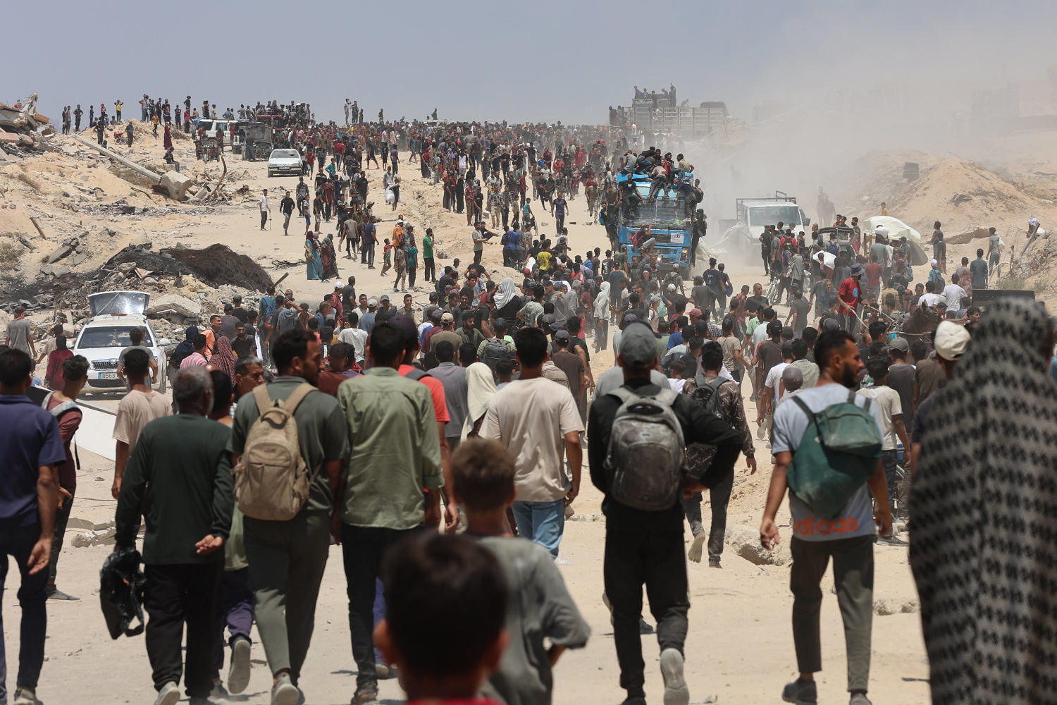 The food is just outside the border. But getting it to Gaza's starving is a chaotic process.