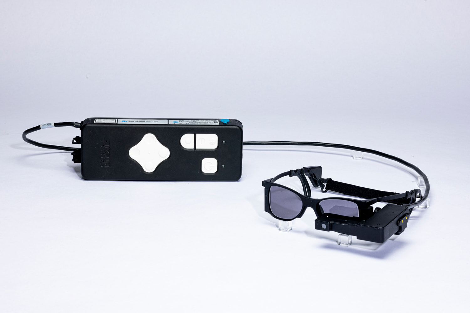 With a tiny eye implant and special glasses, some legally blind patients can read again