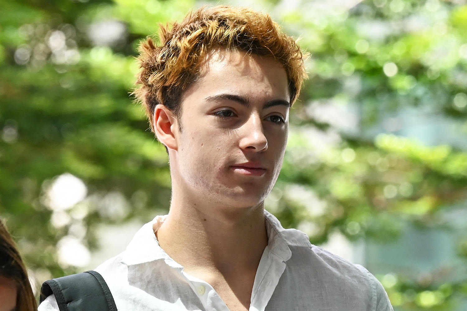 French teen charged in Singapore over a vending machine straw-licking video