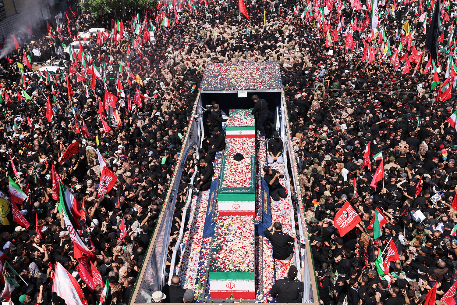 Supreme leader’s coffin creeps through crowds in Tehran as Trump effigy is hanged