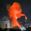 Image: A fireball erupts above Gaza City after an Israeli airstrike on Oct. 9.