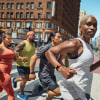 Group of people running in the street wearing Fitbit Charge 6 smart watches.
