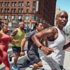 Group of people running in the street wearing Fitbit Charge 6 smart watches.