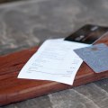 Close-up of credit cards and bill on table in rustic restaurant