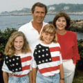 George W., Laura Bush and their daughters Barbara and Jenna wearing matching American flag shirts.