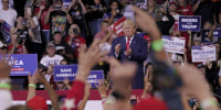 MAGA + QAnon: Trump amplified extreme theories in new messages as MAGA fans raise Q salute