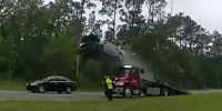 Car flies 120 feet after driving up tow truck ramp at full speed