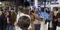 Man dresses as spartan to surprise fiancée at airport