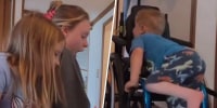 Boy with spina-bifida climbs into wheelchair by himself for first time