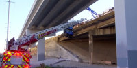 Box truck dangles from Dallas overpass with driver still inside
