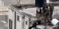 Disturbing video shows Israeli soldiers tipping body of Palestinian man off roof