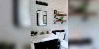 This bathroom's wall of white subway tile only cost $3