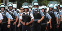 Police officers stands guard as demonstrators stage a rally and march to protest police brutality on August 15, 2020 in Chicago.