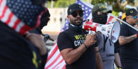 Image: Enrique Tarrio, leader of the Proud Boys, uses a megaphone while counter-protesting people gathered at the Torch of Friendship to commemorate the one year anniversary of the killing of George Floyd on May 25, 2021 in Miami.