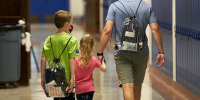 A student and parent pick up technology for remote learning at Mockingbird Elementary School in Dallas, Texas, on Aug. 19, 2020.