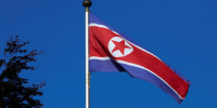 Image: A North Korean flag flies on a mast at the Permanent Mission of North Korea in Geneva.