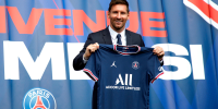 Image: Paris St Germain's Lionel Messi poses with a shirt on the pitch after the press conference.