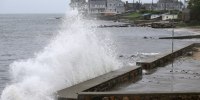 Waves crash against the sea wall along Pequot Avenue in New London, Conn., as Tropical Storm Henri approaches on Aug. 22, 2021.