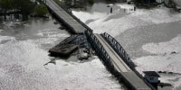 A barge damages a bridge that divides Lafitte, La., and Jean Lafitte, in the aftermath of Hurricane Ida, on August 30, 2021.