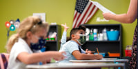 Students wearing masks pay attention on the first day of school at iPrep Academy on August 23, 2021, in Miami.