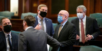 Lawmakers speak prior to the start of a House Rules Committee Hearing at the Illinois State Capitol in Springfield, Ill., on February 10, 2021.