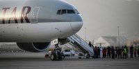 Image: Passengers board a Qatar Airways charter flight carrying foreigners and Afghans to Qatar, at the airport in Kabul, Afghanistan on Sept. 10, 2021.
