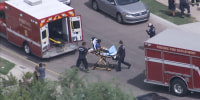 Emergency crews respond to the scene of a shooting in Phoenix on Sept. 27, 2021.