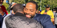 Juwan Deering gets a hug outside the courthouse in Pontiac, Mich., on Sept. 30, 2021, after murder charges against him were dropped in a fire that killed five children in suburban Detroit in 2000.