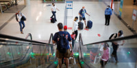 Travelers walk through Midway International Airport in Chicago on Oct. 11, 2021.