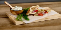 Make grilled chicken gyros in an easy, herbaceous marinade topped with fresh tzatziki in less than 30 minutes.