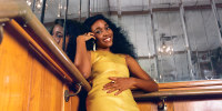 Eyo Edibiri poses on the stairwell surrounded by mirrors at Sugar Hill Supper Club in Bedstuy, Brooklyn.