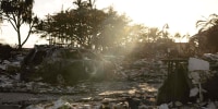 A burnt out car in the driveway of a charred apartment complex in the aftermath of a wildfire in Lahaina, western Maui, Hawaii on Aug. 12, 2023.