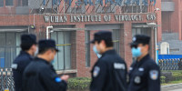 Security personnel stand guard outside the Wuhan Institute of Virology on Feb. 3, 2021.