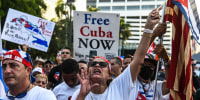 Protesters hold "Free Cuba" signs during a rally in Miami on July 31, 2021.