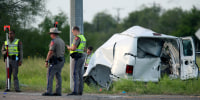 Image: Texas Department of Public Safety officers stand near a van that crashed into a utility pole on Aug. 4, 2021, in Encino, Texas.